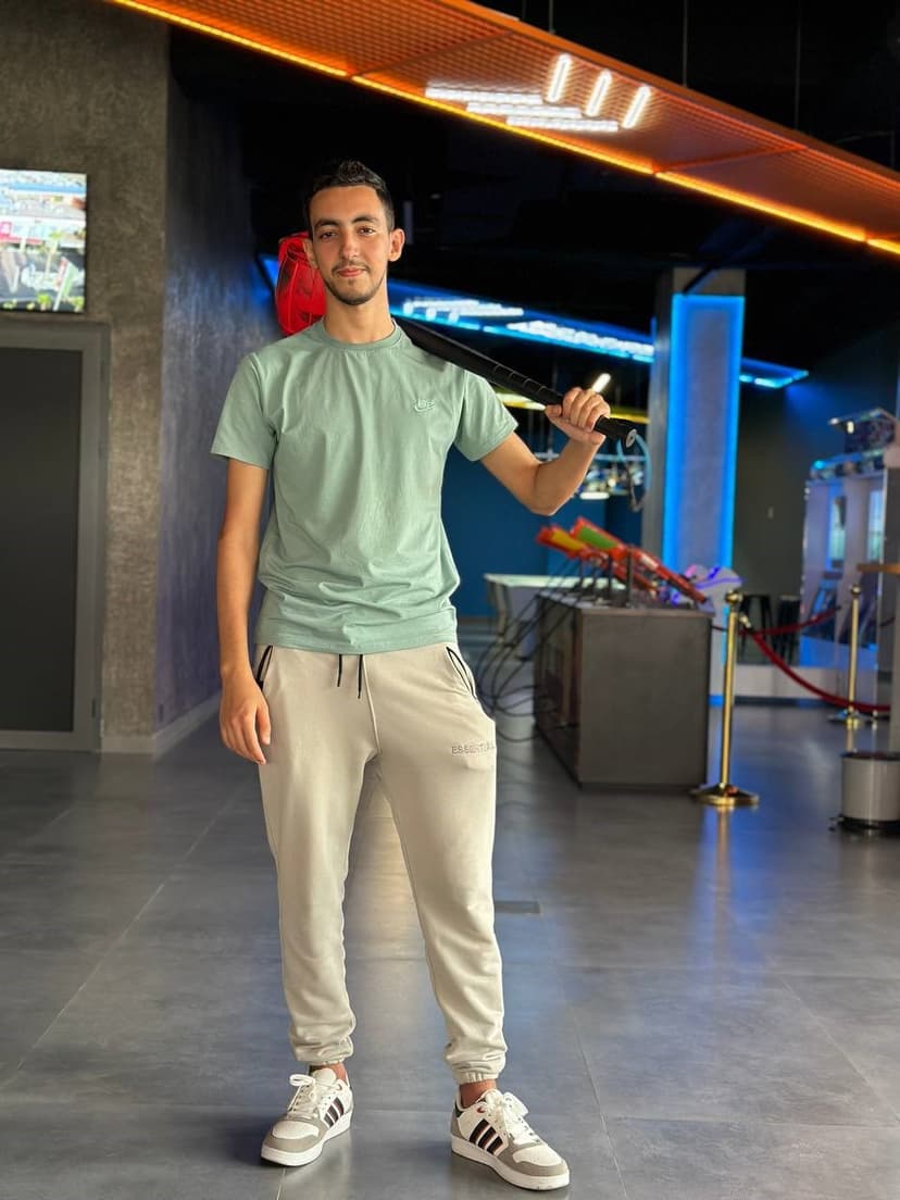 Youssef smiling with a hammer in hand